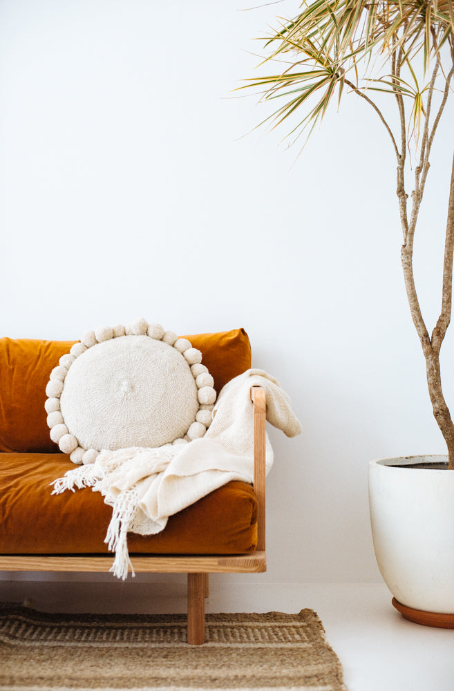 Pampa round white pom pom pillow